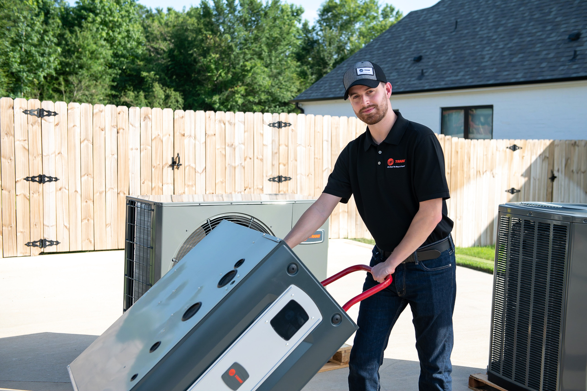 HVAC technician servicing residential outdoor unit