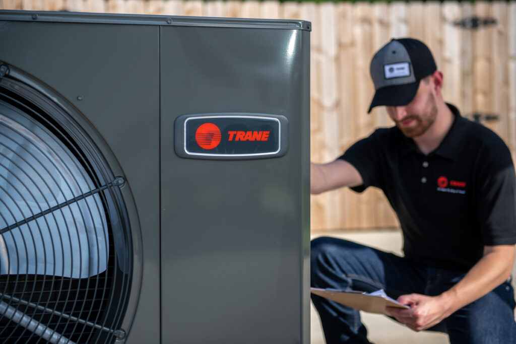 Technician working on indoor HVAC equipment