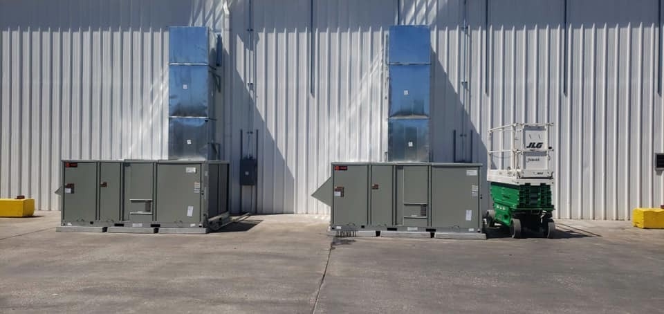 Large commercial HVAC units installed outside modern building