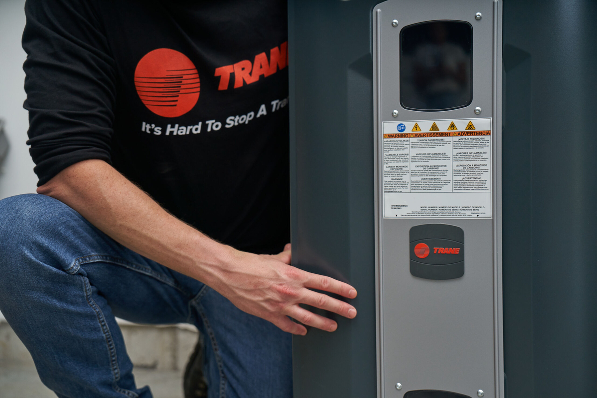 Close-up of technician adjusting HVAC system controls